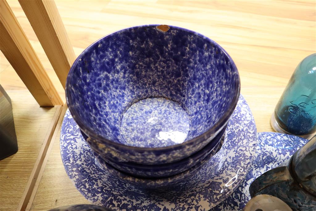 A collection of kitchenwares including a large ironstone jug, 26cm, spongeware bowls, platter, enamel cafeterie, storage jars, cake sta